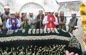 Acting Governor Punjab Malik Ahmad Khan is praying at the Shrine of Data Darbar after placing the Charad