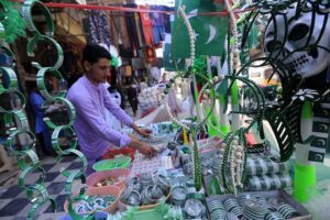 Vendor displaying national flag caps and other celebration stuff to attract the customers in connection with upcoming Independence Day celebrations