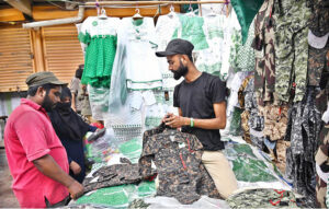 A woman vendor sells bangles and other items at her stall as the nation gears up for Independence Day celebrations.