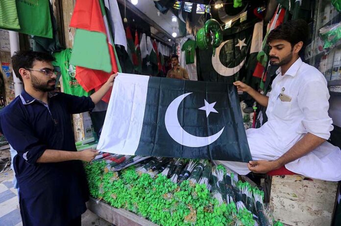Vendor displaying national flag caps and other celebration stuff to attract the customers in connection with upcoming Independence Day celebrations