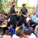 Volunteers distribute food at Sukkur Airport to grieving relatives waiting for the injured and bodies of loved ones martyrs in a recent bus crash in road accident in Iran