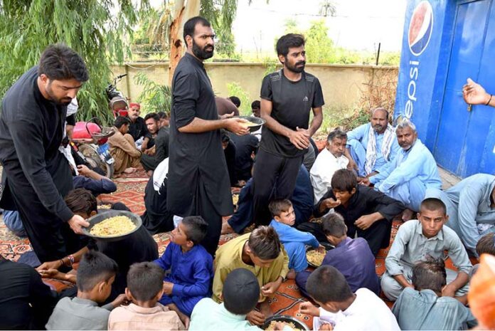 Volunteers distribute food at Sukkur Airport to grieving relatives waiting for the injured and bodies of loved ones martyrs in a recent bus crash in road accident in Iran