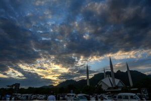 A mesmerizing view of clouds swirling over Faisal Mosque in the Federal Capital, creating a striking backdrop against the iconic architecture.