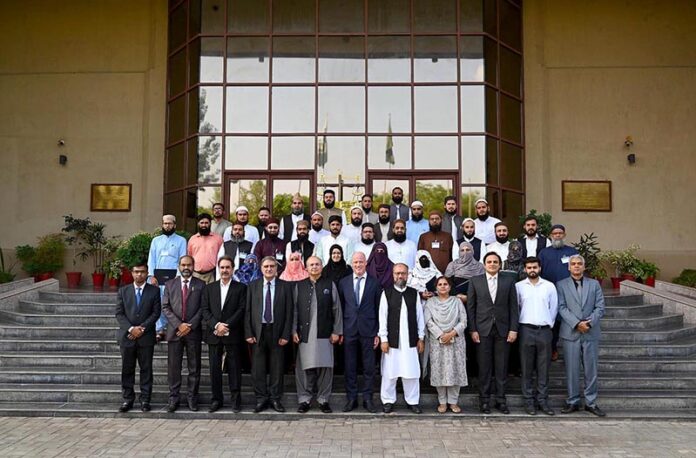 Islamic Scholars from Afghanistan and various universities from all over Pakistan posing group photo with Mr. Justice Syed Mansoor Ali Shah, Judge Supreme Court of Pakistan, at the Federal Judicial Academy
