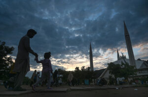 A mesmerizing view of clouds swirling over Faisal Mosque in the Federal Capital, creating a striking backdrop against the iconic architecture.