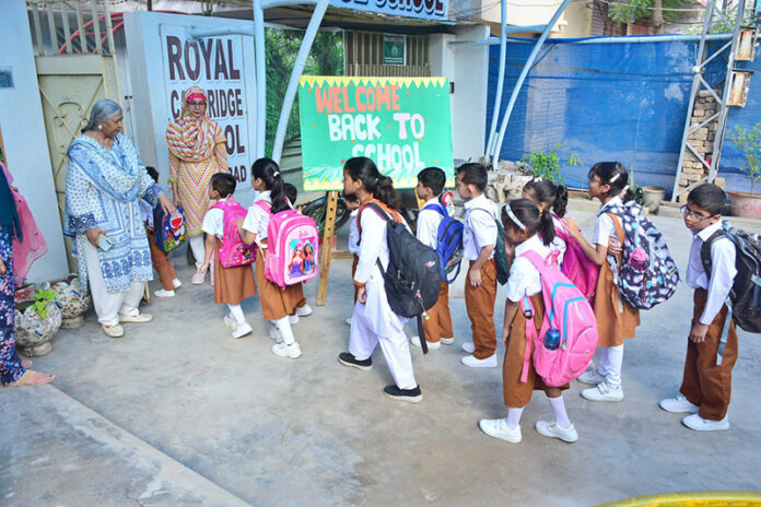 Students return to school in Latifabad, ready to resume classes after a long summer break