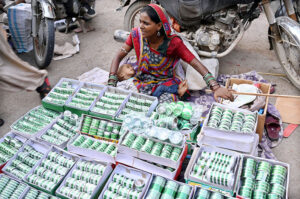 A woman carefully selecting and purchasing national flags, badges, and other celebratory items as the nation gears up to celebrate Independence Day in befitting manners.
