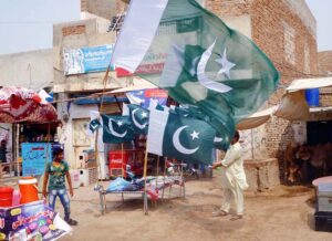 Vendor displaying Pakistan National Flag to attract customers ahead of Independence Day.