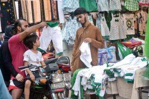 Vendor displaying children clothes in connection with 78th Independence Day celebrations.