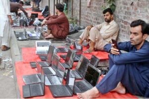 A street vendor displayed used laptops at low prices, attracting customers on his footpath setup in the provincial capital