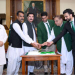 Governor Khyber Pakhtunkhwa Faisal Karim Kundi and Olympics Gold Medalist Arshad Nadeem along with other officials cutting the cake of Independence Day at Governor House
