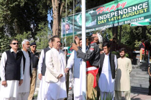 Governor Gilgit-Baltistan Syed Mehdi Shah and Chief Minister Gilgit-Baltistan, Haji Gulbar Khan hoisting flag at Yadgar-e-Shohda to mark the 77th Independence Day of Pakistan