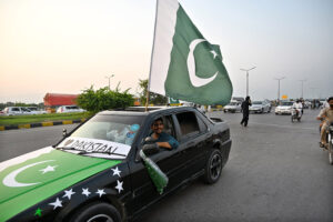 Commuter decorated his car with national flags marching on Islamabad Expressway to celebrate the Independence Day of Pakistan
