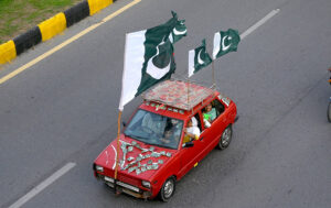 Commuter decorated his car with national flags marching on Islamabad Expressway to celebrate the Independence Day of Pakistan