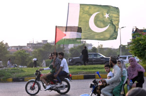 Commuter decorated his car with national flags marching on Islamabad Expressway to celebrate the Independence Day of Pakistan