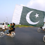 Commuter decorated his car with national flags marching on Islamabad Expressway to celebrate the Independence Day of Pakistan