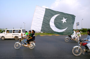 Commuter decorated his car with national flags marching on Islamabad Expressway to celebrate the Independence Day of Pakistan