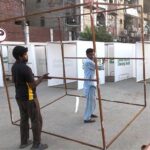 A worker busy in preparing the security gates outside the Data Darbar in connection with 981 Urs Celebration of Data Ali Hajveri(RA)