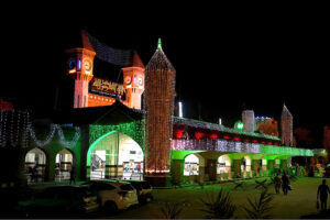 A view of the Civic Center building illuminated with lights on the eve of Independence Day celebrations