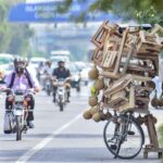 A street vendor waits for customers by displaying a wooden stool and a bird's nest on his bicycle to attract customers in Shukar Parian