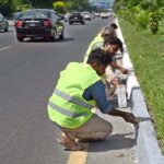 Workers busy repairing cemented blocks at center path of Islamabad Highway