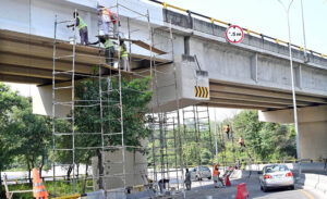 Workers busy paint the bridge at Zero Point in the Federal Capital.