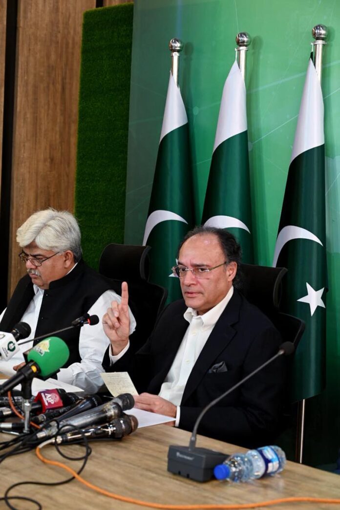 Federal Minister for Finance and Revenue Senator Muhammad Aurangzeb addressing a press conference at PTV Headquarter