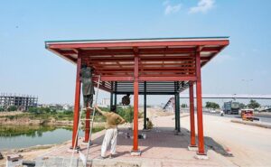 Labourers busy preparing a Blue bus terminal on Islamabad Expressway.