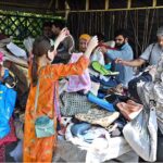 People selecting and purchasing bags from stall at weekly Sunday Bazaar, Aabpara