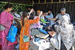 People selecting and purchasing bags from stall at weekly Sunday Bazaar, Aabpara