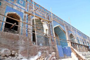 A laborer busy in construction work of Historic legacy of Seven Sisters Graveyard (Satin Jo Asthan Graveyard) Wall, dating back to the Mughal era during the reign of Abul-Qasim Namkin, the esteemed Ameer of Sukkur. In the early 11th Hijra, he arrived in Bakhr, where Mughal King Akbar granted him Jageer. A connoisseur of literature and art, Abul- Qasim Namkin later transformed the hill into a family cemetery, embellishing it with four minarets and corners. Before becoming a graveyard, this location hosted gatherings, meetings and events aptly named "Safae Safa." Referenced in the book "History of Sukkur" by Sindh's renowned historian Rahmidad Molai Shidai, the first grave of Abul-Qasim Namkin was established in 1018 Hijra. The architectural style of the tombs reflects Mughal and Tarkhan influences, adorned with intricate engravings. Legend has it that this site holds stories of seven women seeking refuge from tyrants. Upon reaching this sacred place, they found sanctuary in the mountain, disappearing into its depths. Although lacking historical references, some believe it to be the dwelling of seven elders or elderly women. Today, it stands as a captivating historical site nestled between Sukkur and Rohri at Left Bank of Indus River. Constructed on the mountain in the 17th Hijra, from 1018 AH to 1070 AH (equivalent to 1609 AD to 1659 AD), these tombs showcase small minarets and platforms attached to the hill, with covered floors. Predominantly belonging to the family of Mir Abul-Qasim Namkin, other hills nearby also house graves of notable personalities from that era
