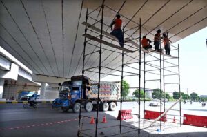 Workers busy repairing cemented blocks at center path of Islamabad Highway