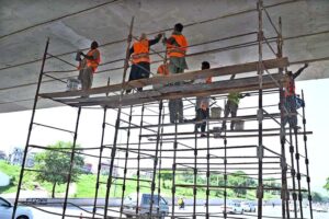 Workers busy repairing cemented blocks at center path of Islamabad Highway