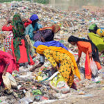 Gypsy women busy in searching the valuables items from garbage at Latifabad