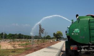 Labourers busy in road construction with the help of heavy machinery during development work near Faizabad.