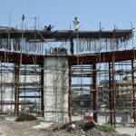 Labourers busy in construction work of flyover at under construction 10th Avenue during development work in Federal Capital