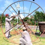 CDA workers busy fixing a tree stand to enhance beauty of Federal Capital in front of Parliament House