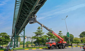 Engineers use a crane to repair CCTV cameras at Shakar Parian Chowk in federal capital