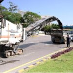 Labourers busy in road construction with the help of heavy machinery at Federal Capital