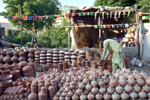 A vendor displaying clay-made items at roadside to attract the customers