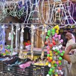 A vendor at Bani Road presents a dazzling variety of colorful lights to attract customers