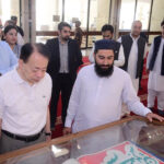 The President of Asian Development Bank Mastasugu Asakawa is seeing the displayed calligraphy art at Faisal Mosque