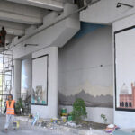 Workers painting the wall of 6th avenue underpass in the Federal Capital