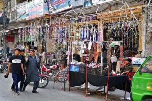 A vendor at Bani Road presents a dazzling variety of colorful lights to attract customers