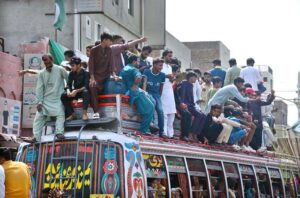 People travelling on a passenger bus rooftop may cause any mishap and needs the attention of concerned authorities.