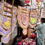 A vendor displaying currency garlands to attract the customers at Faqir Ka Pir Bazaar