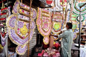 A vendor displaying currency garlands to attract the customers at Faqir Ka Pir Bazaar