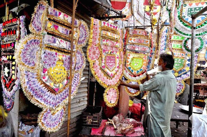 A vendor displaying currency garlands to attract the customers at Faqir Ka Pir Bazaar