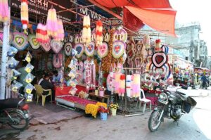 A vendor at Bani Road presents a dazzling variety of colorful lights to attract customers