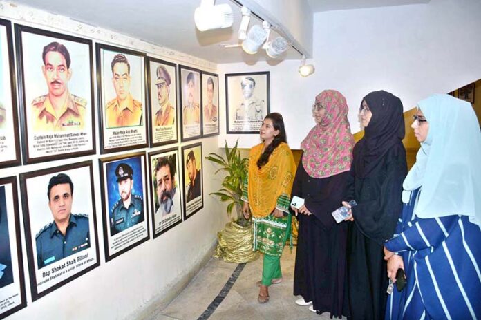 Visitors are keenly viewing pictorial exhibition after inaugurating at FAC Art Gallery to mark Pakistan Defense Day